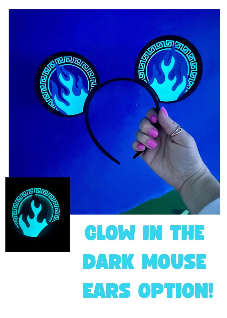 May include: Black mouse ear headband with glowing blue flame design. The ears have a Greek key border. The text "GLOW IN THE DARK MOUSE EARS OPTION!" is displayed in blue. The ears are held up by a hand with pink nail polish.