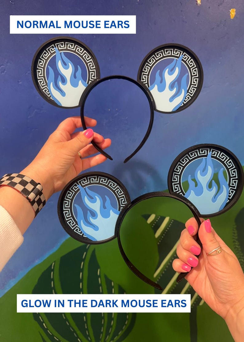 May include: Black headband with circular mouse ears featuring a blue flame design. The ears have a black border with a Greek key pattern. The text "NORMAL MOUSE EARS" and "GLOW IN THE DARK MOUSE EARS" are visible.