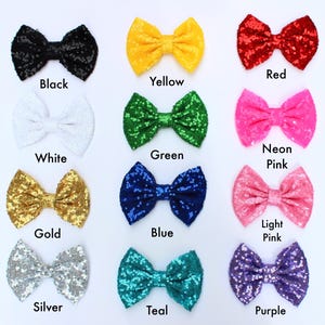 May include: A collection of sequined bow ties in various colors, including black, yellow, red, white, green, neon pink, gold, blue, light pink, silver, teal, and purple. Each bow tie has a matching color label underneath.
