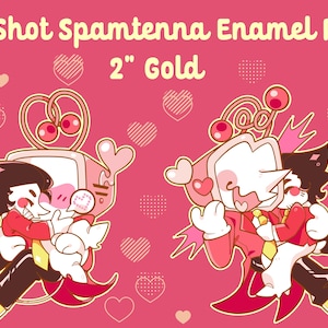 May include: Pink enamel pins with cartoon characters embracing, set against a pink background with heart motifs. The text reads "Big Shot Spamtenna Enamel Pins" and "2" Gold". The pins feature characters in red, black, and yellow.