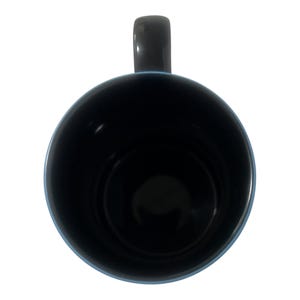 May include: A black ceramic mug with a dark gray handle and a light blue rim. The interior of the mug is black. The mug is viewed from above against a white background.