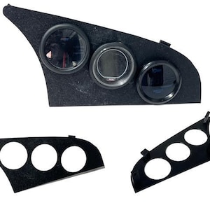 May include: Black automotive gauge pod with three circular openings, one with gauges installed. Two additional gauge pods are shown, one with three openings and another with three openings. The pods are made of a textured black material.