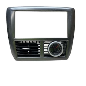 May include: A black plastic car radio dash kit with a rectangular opening for a radio and a vent with a black grille. A round gauge with a white face and black numbers reads "EXT TEMP" and has a red needle.