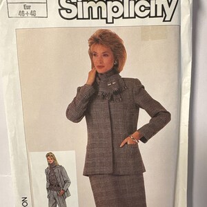 May include: Simplicity sewing pattern envelope featuring a woman in a brown plaid suit with a matching skirt and jacket. The envelope includes the text "Simplicity" and size information, with a smaller image of a woman in a pantsuit.