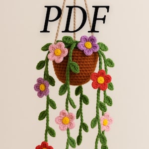 Peut inclure: Un panier suspendu au crochet fait à la main avec des fleurs colorées. Le panier est marron et les fleurs sont rouges, roses et violettes avec des centres jaunes. Des feuilles et des vignes vertes tombent en cascade. Le mot "PDF" est écrit en noir en haut.