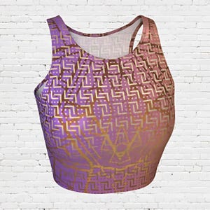 May include: A purple and gold crop top with a geometric pattern. The pattern is made up of small squares and lines.