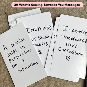 May include: A set of white rectangular cards with black handwritten text. The top card reads 20 What's Coming Towards You Messages. Other visible cards feature phrases including A Sudden Shift in Perspective on a Situation, Improving your Spending habits, and Incoming unexpected love Confession with a heart symbol.