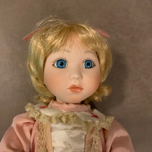 Vintage 1990’s Victoria Impex 9 1/4” Doll in woven seated wooden chair. Pretty Doll in Pristine Condition!!