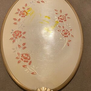 Vintage Beautiful Gold Tone Oval Mirror with a beautiful Rose Decorative Back. 1950’s-1960’s  Mirror and handle overall length is 13 3/4”.