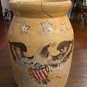 Vintage Painted Butter Churn 9” X 13” Tall. Beige  with a Eagle and Stars Pattern. Fair to Good Condition with Some Repairs.