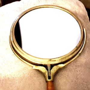 Vintage French 1950’s-1960’s Swivel/Tilting 5” Mirror with Bakelite Handle. Mirror and handle overall length is 10”.