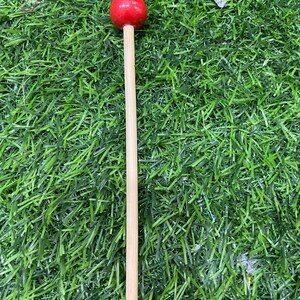 May include: A wooden mallet with a red rubber head. The mallet is used for playing musical instruments.