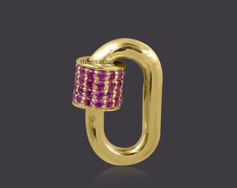 May include: Gold-toned oval-shaped charm with a pink gem-encrusted barrel-shaped clasp. The charm is a popular style for jewellery making.