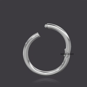 May include: A silver hoop earring with a ball closure. The earring is open and ready to be worn.