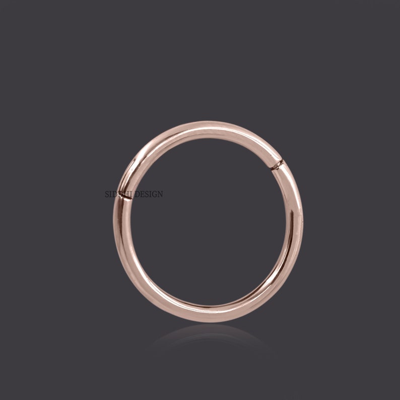 May include: A rose gold seamless ring for body piercing. The ring is made of surgical steel and is available in a variety of sizes.
