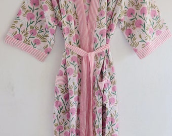 May include: A pink and white floral print robe with a pink and white striped trim. The robe has a tie belt and two pockets.