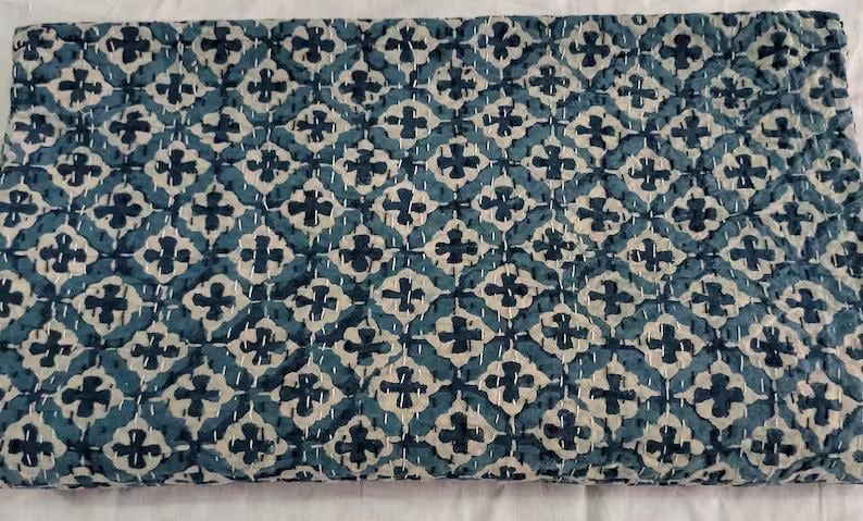 May include: A blue and white kantha quilt with a geometric pattern. The quilt is made of cotton and is hand-stitched.