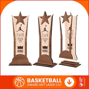 May include: Three wooden basketball trophies with a star on top. Each trophy features a basketball player silhouette, basketballs, and the word "KING". The trophies are laser cut and have a dark brown and light brown color scheme.