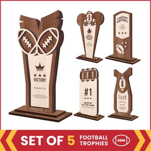 May include: A set of five wooden football trophies featuring light and dark wood grain finishes. Each trophy displays engraved text including Victory, Fantasy Football, Best Match 2025, and Master of the Game, along with football icons and stars.