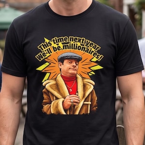 May include: A black t-shirt featuring a graphic of a person wearing a flat cap, a red turtleneck, and a tan shearling-lined coat. The person holds a cigar and wears a gold necklace with a D pendant. Text reads: This time next year We'll be millionaires!