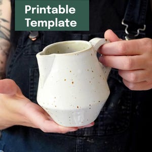 May include: A speckled white ceramic pitcher with a geometric design. The pitcher has a handle and a spout. The text "Printable Template" is in a green rectangle in the upper left corner.