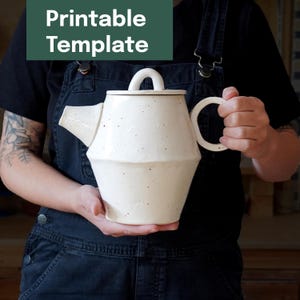 May include: A cream-colored ceramic teapot with a geometric design. The teapot has a curved handle, a spout, and a lid. The text "Printable Template" is in a green rectangle in the upper left corner.