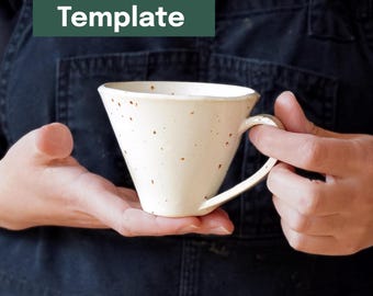 May include: A cream-colored ceramic mug with a unique, angular design. The mug has a handle and is speckled with brown spots. The text "Printable Template" is in a green rectangle above the mug.
