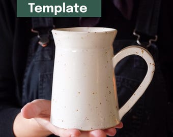 May include: A handmade, off-white ceramic mug with a large handle. The mug has a speckled texture and a slightly flared rim. The text "Printable Template" is in a green rectangle in the upper left corner.