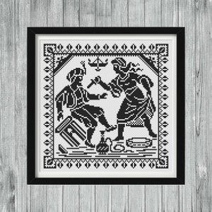 May include: A black and white cross-stitch pattern featuring a square decorative border enclosing a scene of two figures interacting. One figure sits on a stool while the other stands, with a small pitcher and bowl placed on the ground between them.