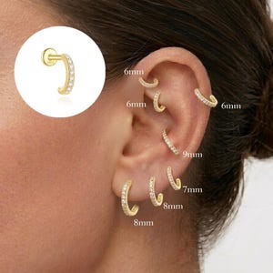 May include: Gold-tone hoop earrings featuring a row of small clear stones. The earrings are displayed in various sizes including 6mm, 7mm, 8mm, and 9mm, with a circular inset showing a single earring with a post back and the text 925 engraved.