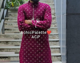 May include: A man wearing a maroon kurta with a white pattern and white pants. He is standing on a set of stairs. The kurta has a button-up closure and a collar. The man is wearing brown shoes. The text "AchhicPalette ACP" is visible on the kurta.
