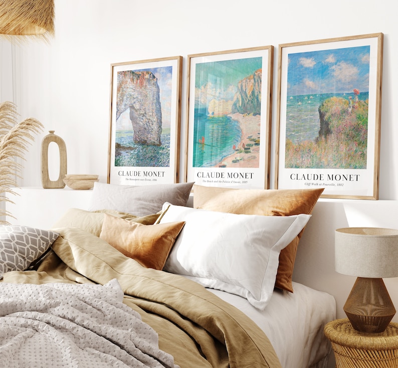 May include: Three framed art prints of seascapes by Claude Monet. The prints feature the text "Claude Monet" and the title of each painting. The paintings are "The Etretat Needle", "The Beach and the Rocks of Etretat", and "Cliff Walk at Pourville".