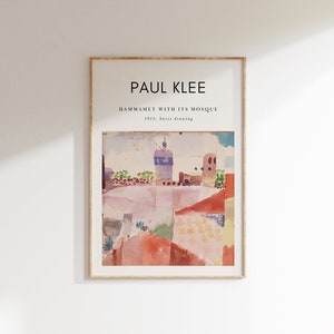 May include: A framed print of a watercolor painting by Paul Klee titled "Hammamet with its Mosque" from 1914. The painting depicts a colorful landscape with a mosque in the background.