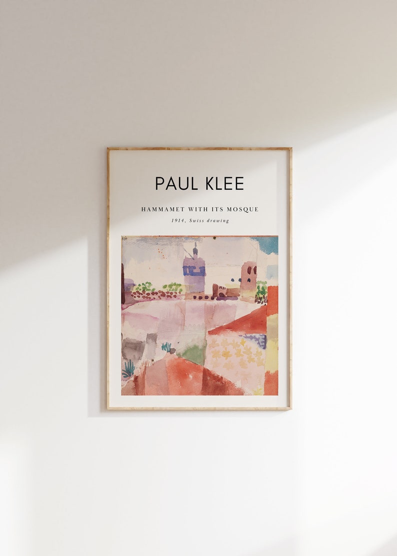 May include: A framed print of a watercolor painting by Paul Klee titled "Hammamet with its Mosque" from 1914. The painting depicts a colorful landscape with a mosque in the background.