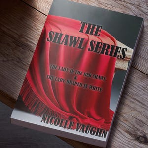 May include: Book cover featuring a red shawl with the text "The Shawl Series: The Lady in the Red Shawl & The Lady Draped in White" and the author's name "Nicolle Vaughn".