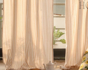 May include: Two beige and white striped curtains hang in a window with a jute rug on the floor. A white teapot and sugar bowl are on the rug. A pillow with a sunflower pattern is on the rug. The text "Weave Home" is visible in the image.