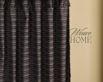 May include: Dark gray and white striped curtain panel with black tie closures at the top. The curtain is hanging from a wooden rod. The text "Weave HOME" is visible on the right side of the image.