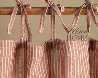 May include: Two red and white striped fabric valances with a wooden rod and tied with bows. The valances are made of a woven fabric with a subtle texture.
