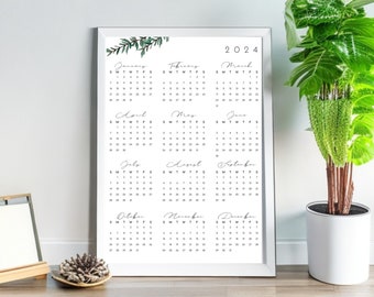 May include: A white framed calendar with a floral design at the top. The calendar is for the year 2024 and includes all 12 months.