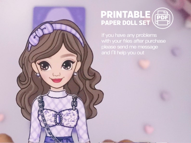 May include: Printable paper doll set featuring a cartoon girl with brown hair wearing a purple and white checkered top, a purple headband with a bow, and a silver chain necklace. The text "PRINTABLE PAPER DOLL SET" and "PDF" are visible in the image.
