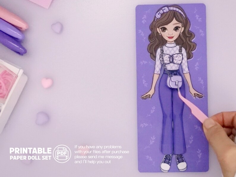 May include: Printable paper doll set featuring a cartoon girl with brown hair wearing a white and black checkered top, blue jeans, and a light blue handbag. The doll is on a purple background with floral accents.