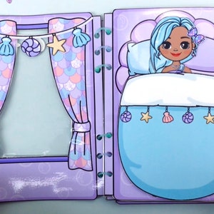 May include: A paper doll playset featuring a mermaid theme. The open book shows a bedroom scene with a mermaid doll in bed, and a window with curtains. The curtains and bedspread are light blue, and the room is decorated with seashell and star ornaments.
