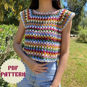May include: A colorful, crocheted top with a square pattern in shades of pink, blue, yellow, green, and white. The top has a round neckline and short sleeves. The text "PDF PATTERN" is visible in the lower left corner.