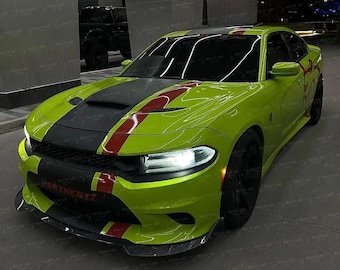 May include: A lime green Dodge Charger with a black hood and red racing stripes. The car has black rims and the text "SRTHERTZ" on the front bumper. The car is parked in a modern outdoor setting.