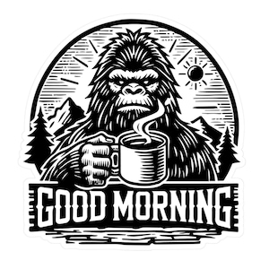 May include: Black and white illustration of a Bigfoot holding a steaming cup of coffee. The image is set in a forest with mountains in the background. The text "GOOD MORNING" is below the image.