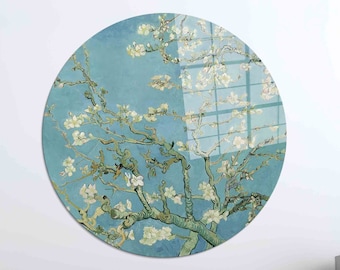 May include: A round wall art piece featuring a painting of a blooming almond tree with white flowers against a light blue sky. The painting is in a style reminiscent of Vincent van Gogh.