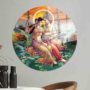 May include: A colorful painting of a couple on a swing, surrounded by lotus flowers. The woman is wearing a yellow and pink sari, and the man is wearing a blue and green dhoti. The background is a vibrant sunset.