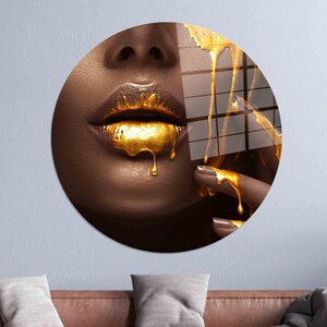 May include: Close-up of a person's face with gold paint dripping from their lips and onto their finger.