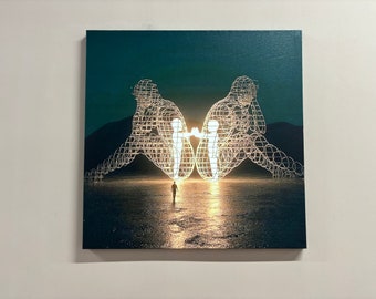 May include: A black and white image of two large, glowing, wire-frame figures facing each other. A smaller figure walks towards the figures in the middle of the image.