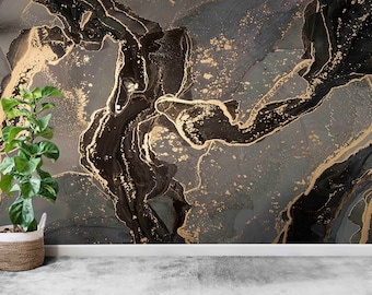 May include: A gray and black abstract wall mural with gold accents. The mural features a swirling, marbled pattern. A potted plant sits in front of the wall.